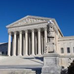 United States Supreme Court building with clear blue sky.