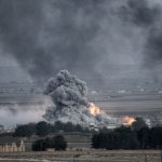Smoke and fire rise from explosion in city landscape