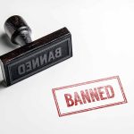 Rubber stamp with banned text on paper
