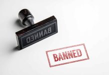Rubber stamp with banned text on paper