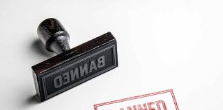 Rubber stamp with banned text on paper