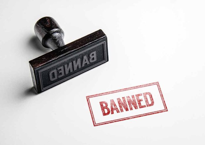 Rubber stamp with banned text on paper