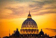 Dome of a cathedral at sunset with orange sky