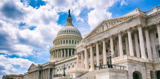 United States Capitol building with cloudy blue sky