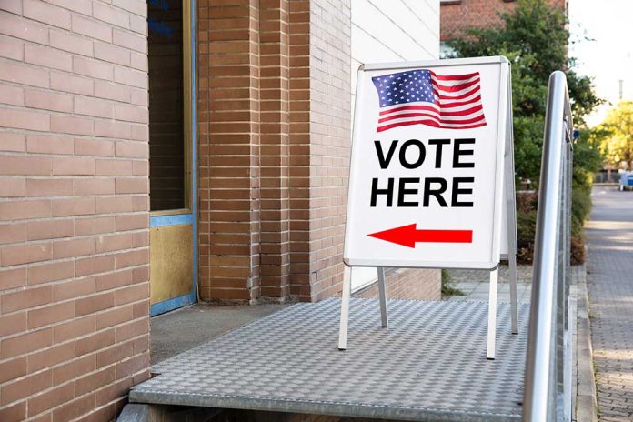 1239383353 featured image Voting sign outside building with American flag visible