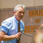 Man speaking outside House of Representatives building