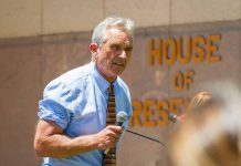 Man speaking outside House of Representatives building