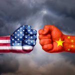 USA and China flags on clenched fists facing off