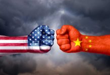USA and China flags on clenched fists facing off