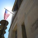 American flag at Department of Justice building exterior