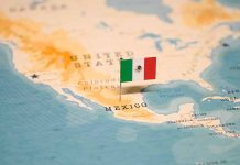 Mexican flag pin on map of Mexico