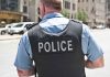 Police officer in uniform standing on city street