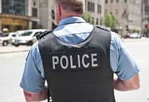 Police officer in uniform standing on city street