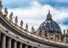 St. Peter's Basilica dome with statues and clouds
