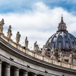 St. Peter's Basilica dome with statues and clouds