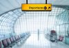 Yellow departures sign in empty airport terminal