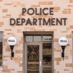 Police department building with brick exterior and signage.