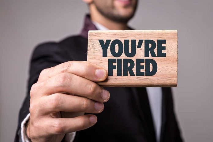 624857621 featured image Man holding Youre Fired sign card