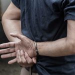 Person in handcuffs with hands behind back