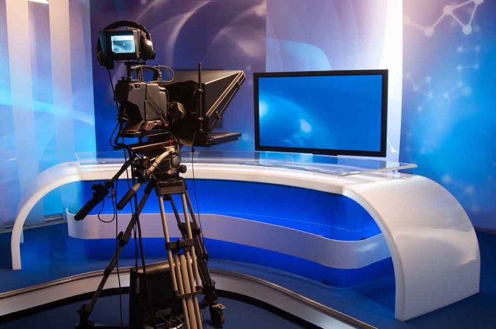 115378765 featured image TV studio with camera and empty anchor desk.
