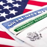 Social Security card and green card on flag