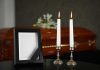 Casket photo frame and two lit candles