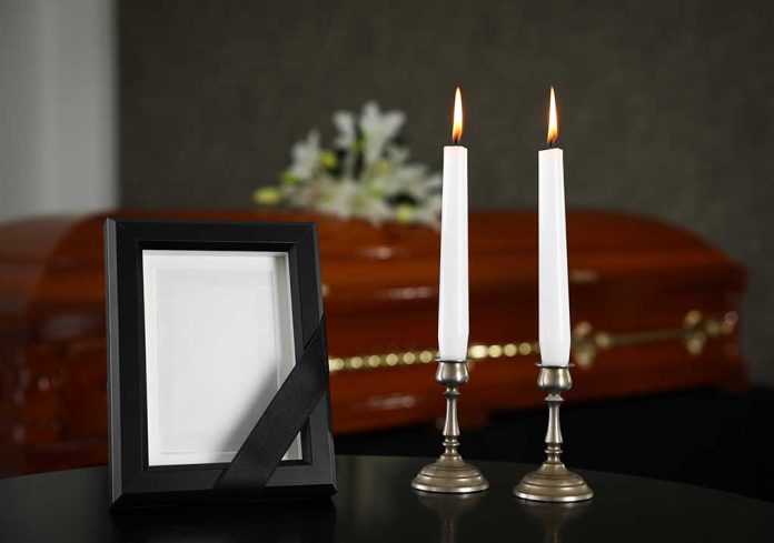 1480856555 featured image Casket photo frame and two lit candles