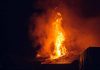 Building engulfed in large flames at night
