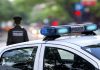 Police car and officer on a city street