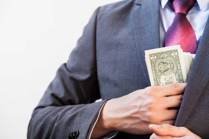 394112617 featured image Person in suit putting money in jacket pocket.