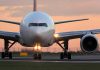 Airplane on runway during sunset