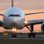 Airplane on runway during sunset
