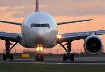 Airplane on runway during sunset