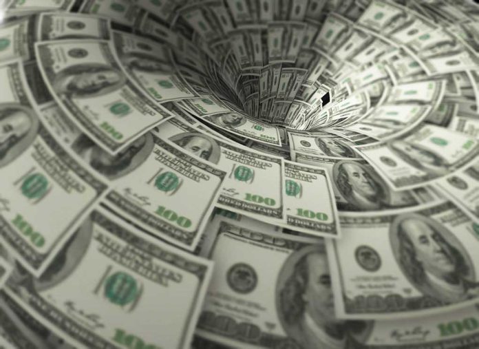 Hundred dollar bills swirling into a financial vortex