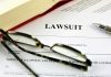 Lawsuit document with glasses pen and book