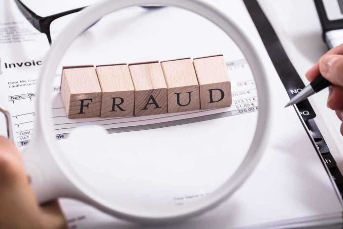 Fraud blocks under magnifying glass on invoices