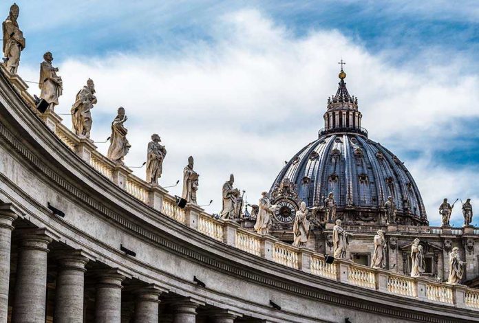 368201633 St Peters Basilica dome with statues and clouds