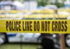 Yellow police line tape with Do Not Cross