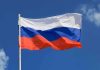 The flag of Russia waving against a clear blue sky