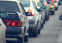 A line of cars stuck in traffic on a roadway