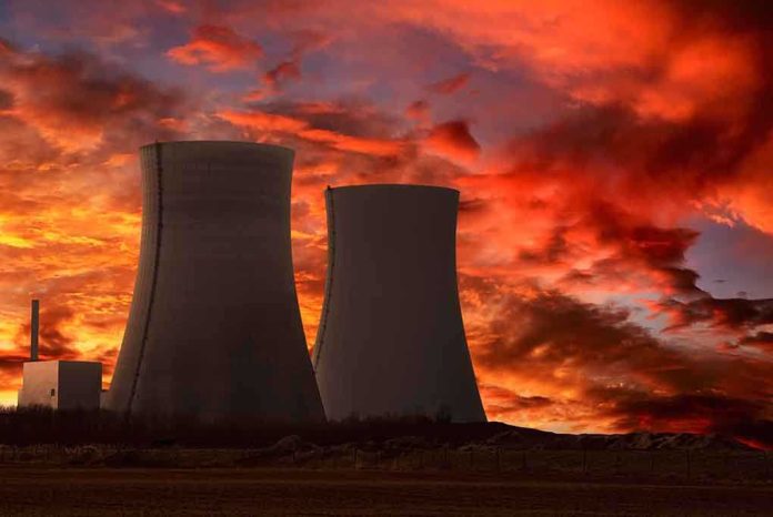 shutterstock_73078270.jpg Silhouette of cooling towers against a vibrant sunset sky