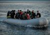 People on a packed raft in open water