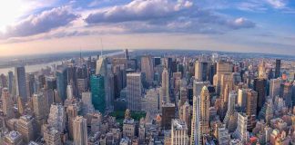Aerial view of city with skyscrapers and cloudy sky