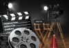 Movie set with film reels and clapperboard