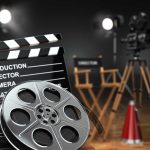 Movie set with film reels and clapperboard