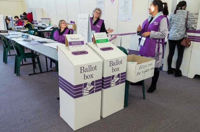 446230945 Election polling station with ballot boxes and officials.
