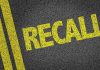 Yellow "RECALL" text on asphalt background.