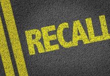 Yellow "RECALL" text on asphalt background.