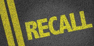 Yellow "RECALL" text on asphalt background.