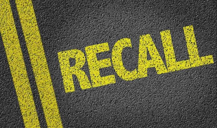 486784426 Yellow "RECALL" text on asphalt background.